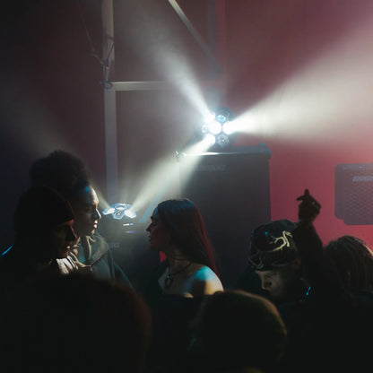 People at a concert with soundboks and lightboks in the background